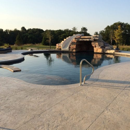 Concrete pool in Iowa City Iowa with slide and white concrete