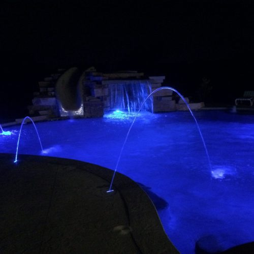 Water fall and laminars in pool at night