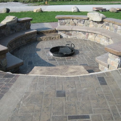 In ground fire ring with decorative stamped patio